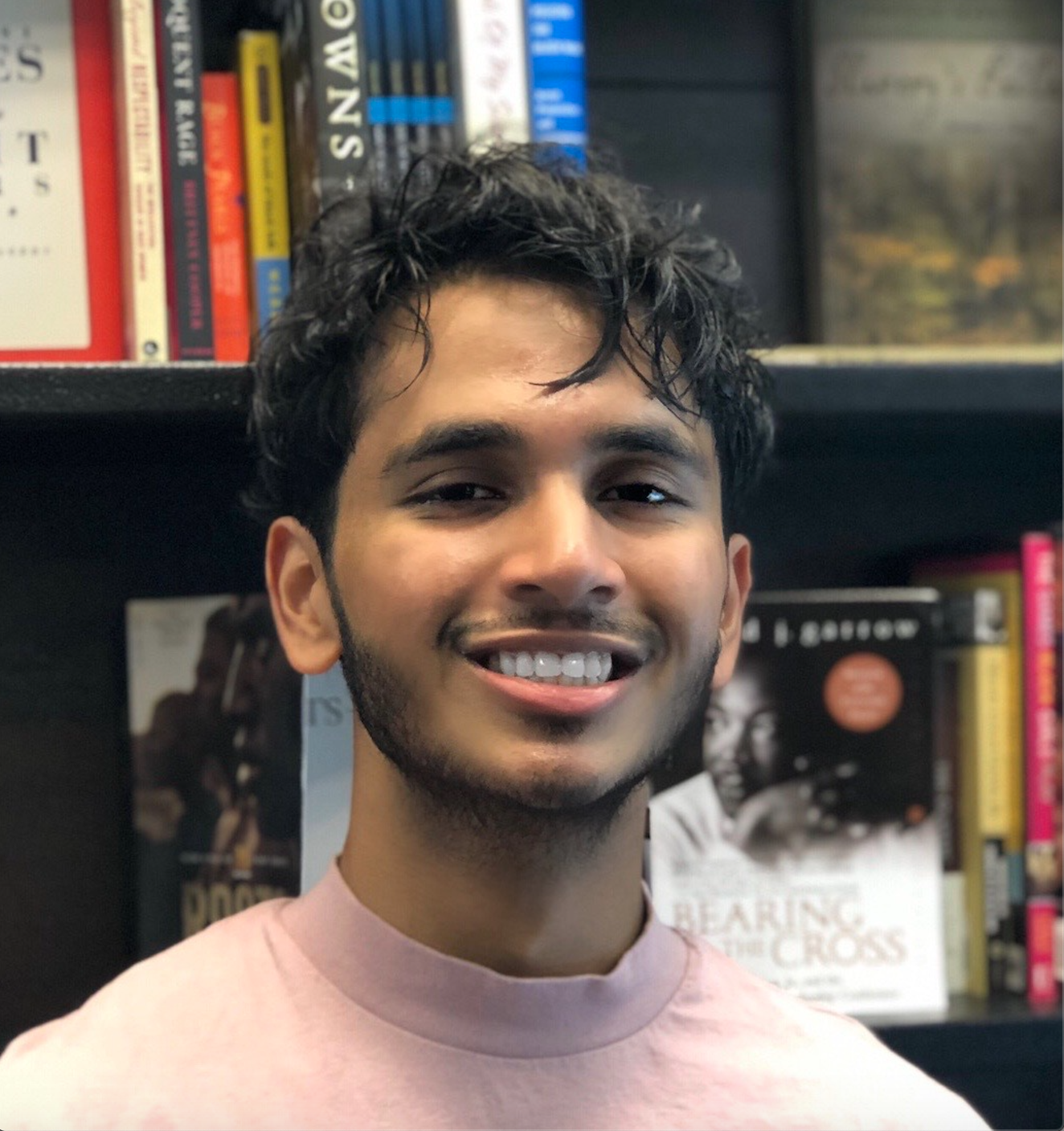 Headshot of a student in front of a bookcase